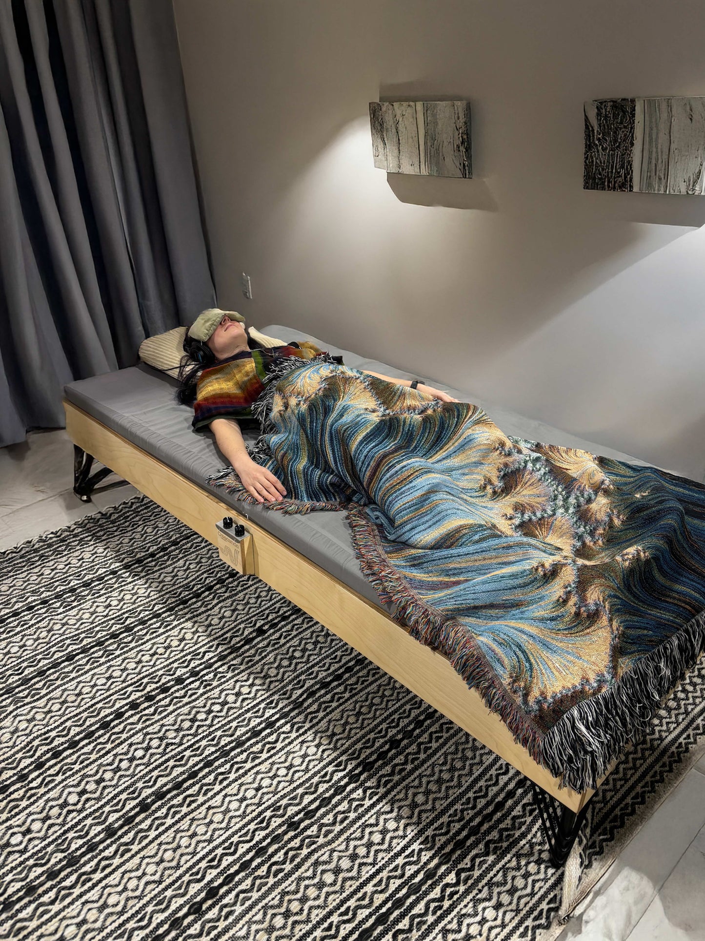 A baltic birch Crescendo Daybed with a listener in a wellness setting
