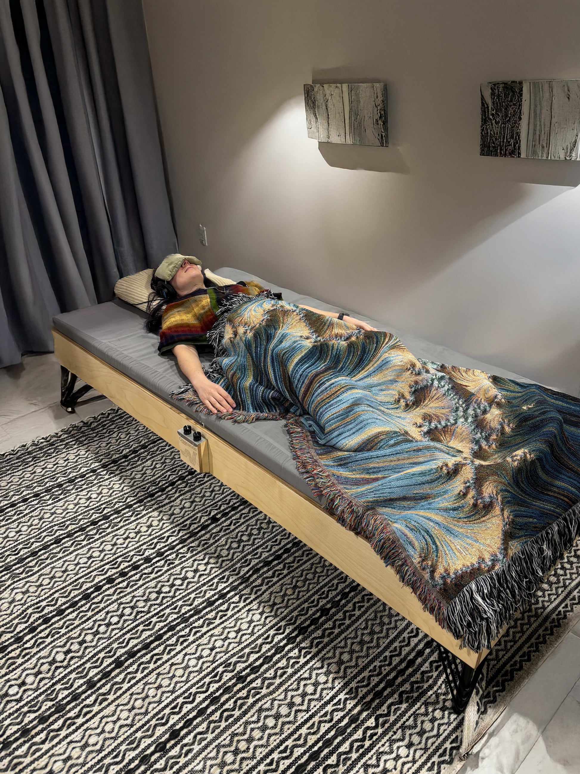 A baltic birch Crescendo Daybed with a listener in a wellness setting