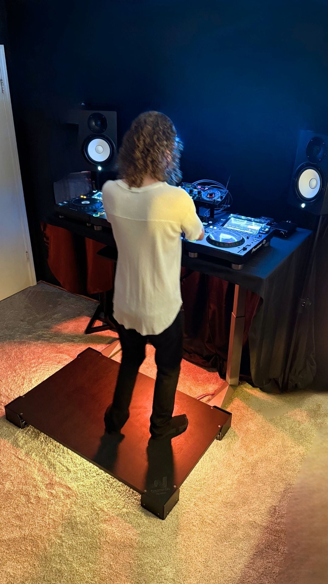 A DJ mixes music while using a Crescendo Studio Tile