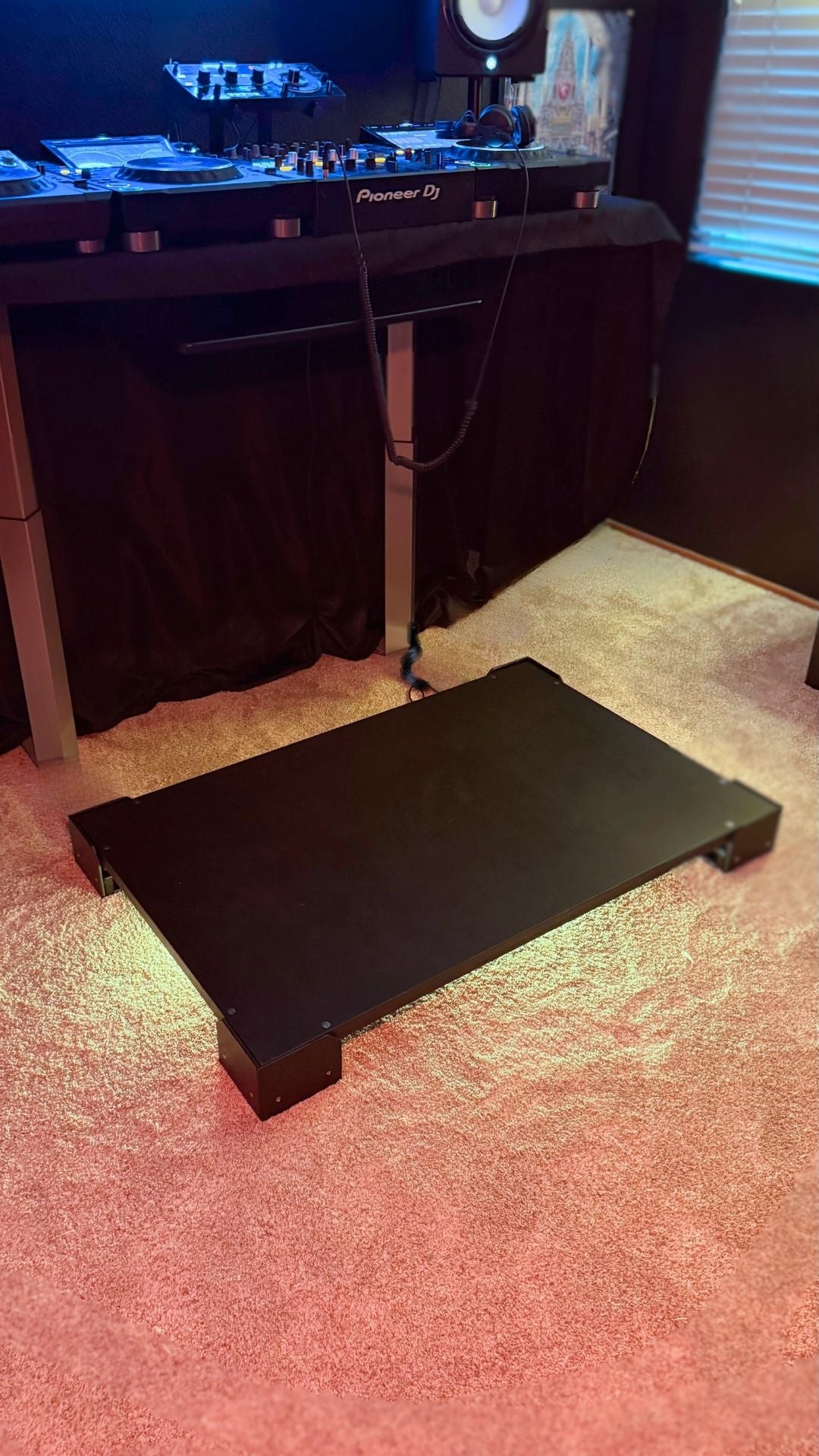 A Crescendo Studio tile placed in front of a table with DJ gear